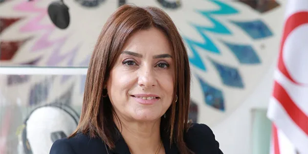 Etkinlikte konuşan kadınlar ve dinleyiciler; pankartlar ve mikrofonlar görünüyor