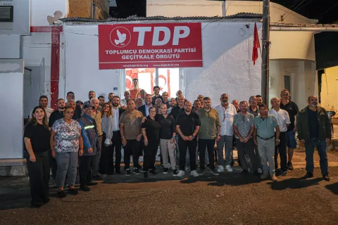 TDP üyeleri Geçitkale’de yeni örgüt binasının açılışında bir arada, parti pankartları ve konuşma yapan kişiler görülüyor