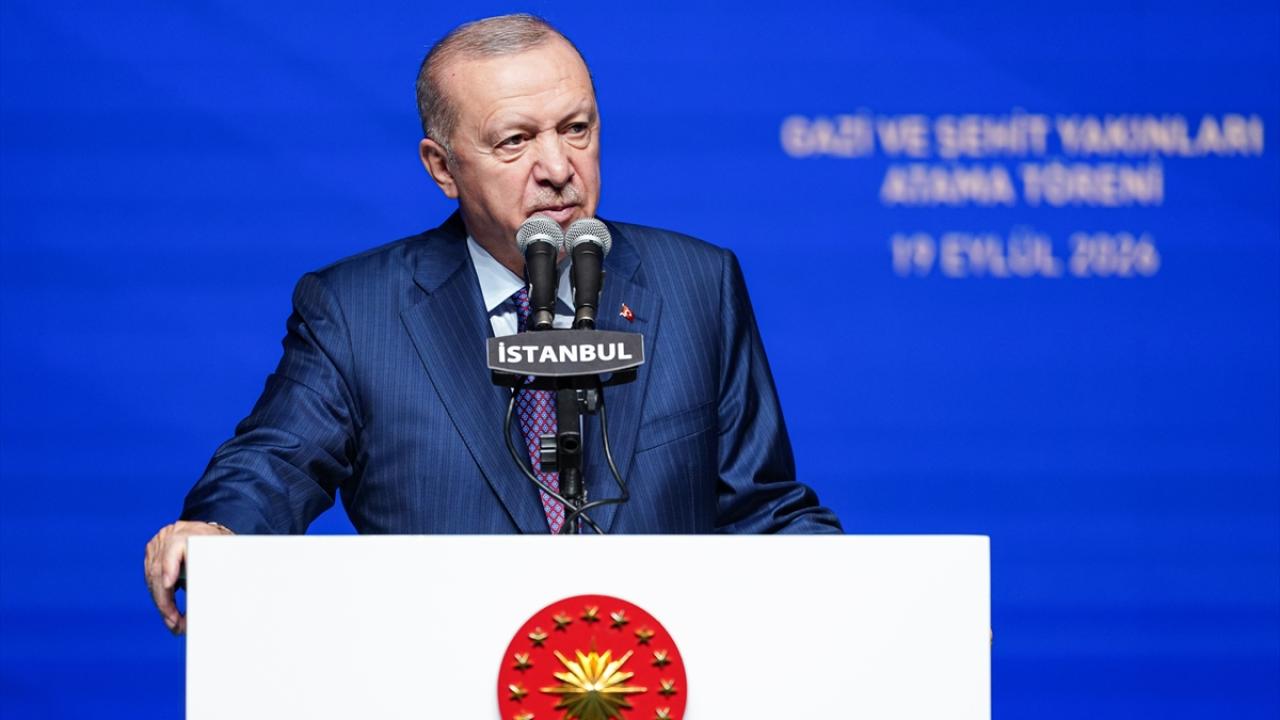 Cumhurbaşkanı Erdoğan konuşma yaparken mikrofon önünde, ciddî bir ifade