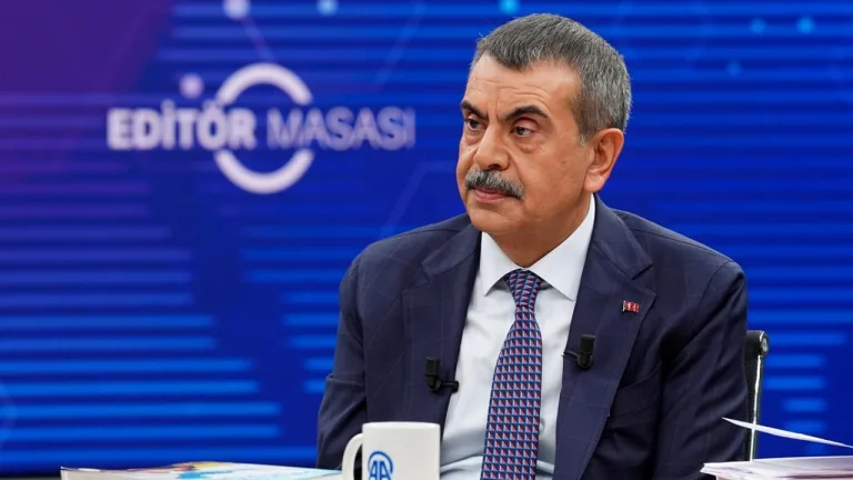 Bakan Tekin konuşurken kürsüde mikrofon ve arka planda PISA görseli