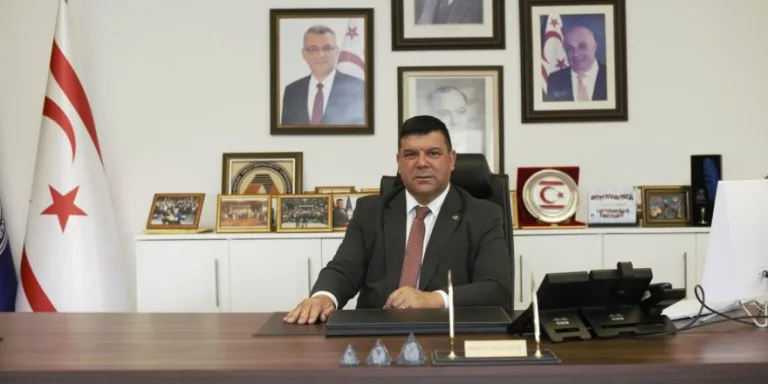 Prof. Dr. Hasan Kılıç konuşurken mikrofon önünde görünür.