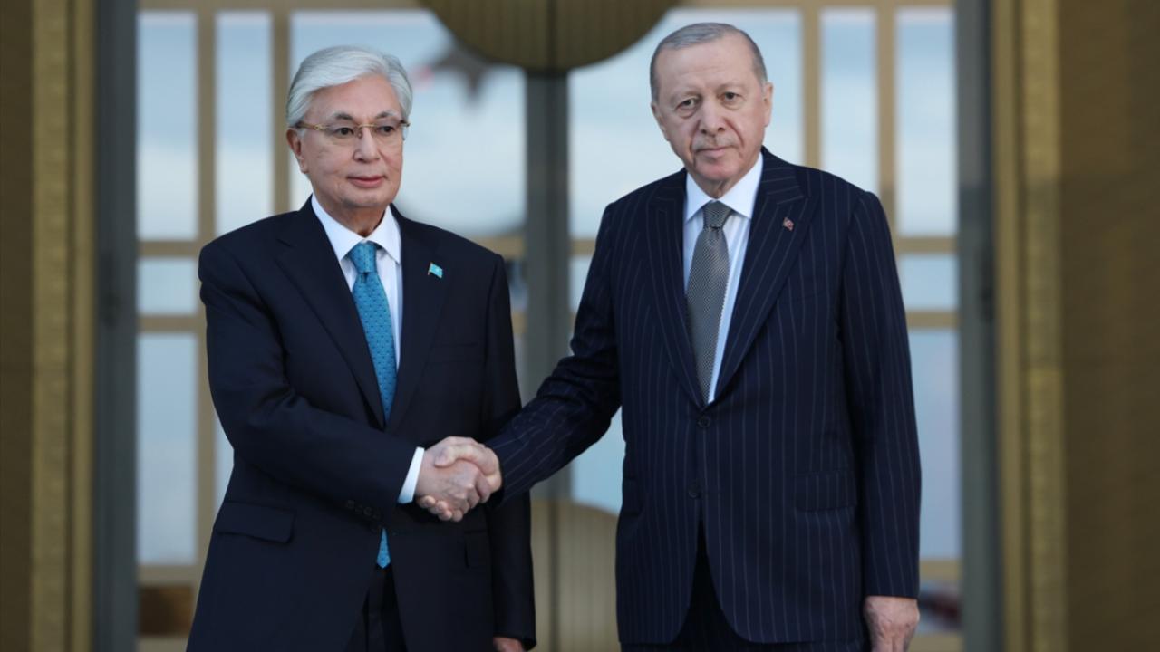 Cumhurbaşkanı Erdoğan ve Kazakistan Cumhurbaşkanı Tokayev el sıkışırken karşılıklı sohbet ediyor